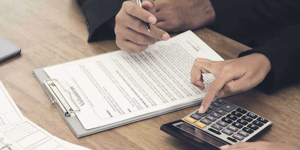 Worker using calculator